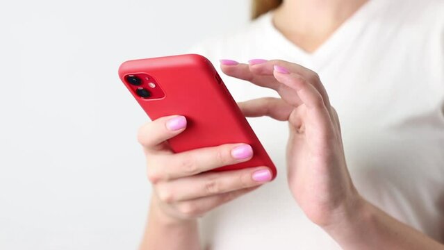 woman scrolling smartphone in hands close-up