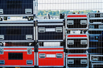 Concert equipment in metal boxes prepared for installation on a concert stage. Warehouse of musical...