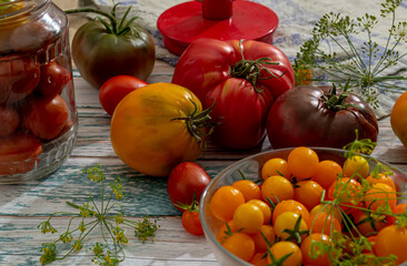 Fresh tomatoes on a wooden kitchen table in a rustic house.