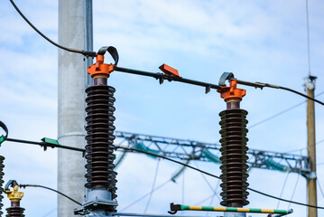 High voltage power transformer substation.High voltage electric power transformers in the blue cloudy sky and trees.