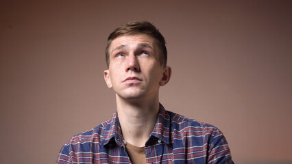 Tired young caucasian man massaging the temples of the head. headache.