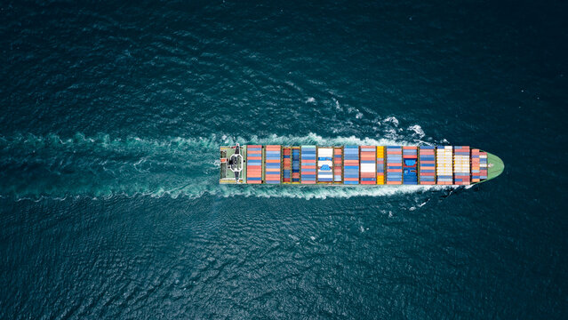 container ship to import export marine goods to dealers and consumers across the pacific and around the world, businesses and industries Ocean freight forwarding, processing blue tone cinematic