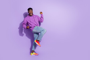Full length photo of delighted successful person raise fists celebrate luck isolated on purple color background
