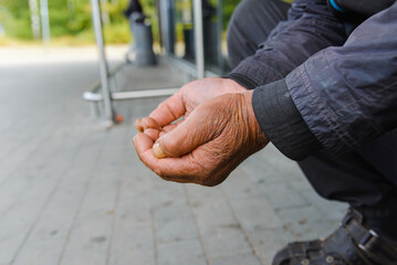 Begging. Outstretched hands.A real homeless person. Diminution of money. Poor man. A beggar in the transition. An unemployed citizen.Stink and dirt.