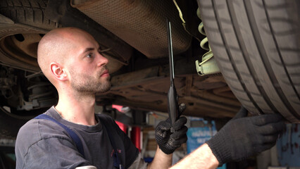 Car diagnostics. an auto mechanic inspects a car. auto repair shop. breaking. transmission