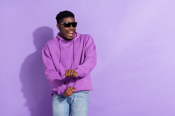 Portrait of excited cheerful man enjoy chilling entertainment free time isolated on violet color...