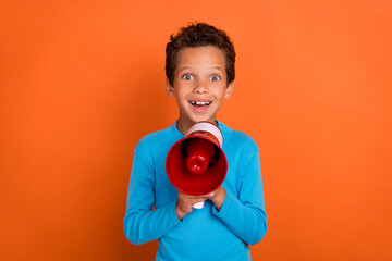 Photo portrait of cute small boy hold megaphone excited activist shopping dressed stylish blue...