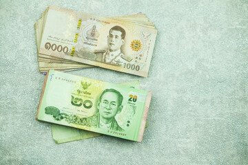 The bank money 20 and 1000 Thai baht is used in exchange for goods. Prepare to clean the banknotes with alcohol for payment cost of good