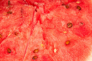 Melon culture. An annual herbaceous plant. Sliced sweet watermelon. Background of cut red ripe...