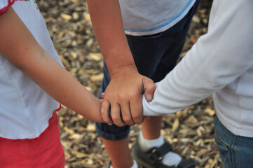 Friendship. Children hold hands as a sign of reconciliation.