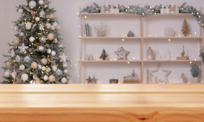 Christmas background. Empty wooden table on the background of a Christmas tree and a beautifully decorated shelf with Christmas decor.Ready for product montage. Copy space.Mockup.