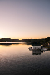 Naklejka na ściany i meble Tranquil sunset on wharf of fishing community in Newfoundland, Canada.