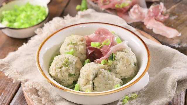 North italian traditional dish. Canederli or Knodel in broth with green onion, typical pasta for Trento, Alps, Alto Adige, Italian, Austrian cuisine. High quality 4k footage. 