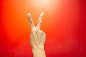 Concept image, hand and fingers human gestures symbols on live colored background with empty space.