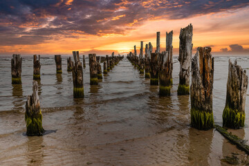 Old abandoned jetty or wooden pier remains on a Baltic sea