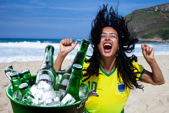 woman celebrating goal drinking beer