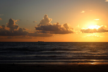 sunset over the beach in the sea.