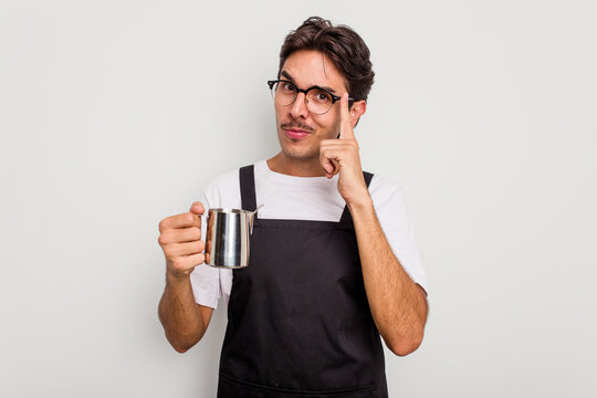 Young hispanic barista man isolated on white background pointing temple with finger, thinking, focused on a task.