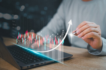 Data statistical index graph on virtual screen concept , Businessman use laptop and point development on stock market data and stock exchange, stock market financial analysis graph.