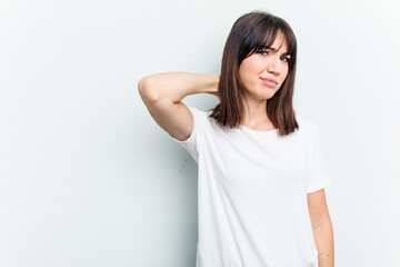 Obraz premium Young caucasian woman isolated on white background touching back of head, thinking and making a choice.