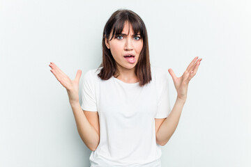 Young caucasian woman isolated on white background screaming to the sky, looking up, frustrated.