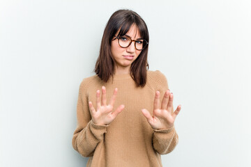 Young caucasian woman isolated on white background rejecting someone showing a gesture of disgust.