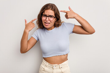 Young caucasian woman isolated on blue background showing a disappointment gesture with forefinger.