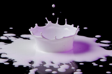 Drop of white paint on Black background