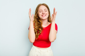 Fototapeta premium Young caucasian woman isolated on blue background joyful laughing a lot. Happiness concept.