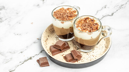 dessert three chocolates pudding decorated with mint on a light background. Layered delicious dessert. Long banner format