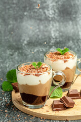 dessert three chocolates with mint on a dark background. Layered delicious dessert. vertical image. place for text