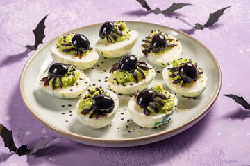 Deviled eggs with avocado. Spider for Halloween party