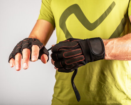 Wearing, Putting On Sport Workout Gloves Close Up For Palm And Wrist Protection In Gym