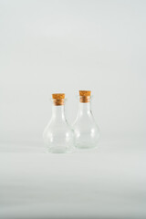 small glass bottles isolated in front of white backdrop