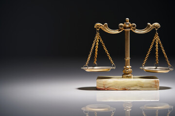 close up of libra scale against gray background