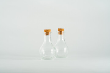 small glass bottles isolated in front of white backdrop