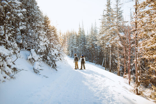 Couple on sunlit snowy slope