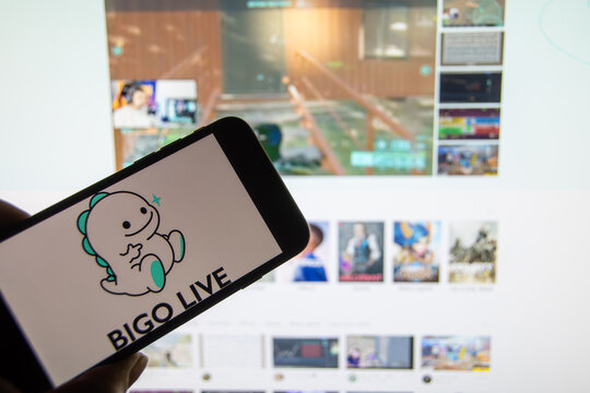 Rheinbach, Germany  18 January 2022,  The brand logo of the live stream platform "Bigo TV" on the display of a smartphone in front of the website (focus on brand logo)