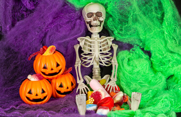 Halloween parties. Skeleton sitting and surrounded by treats and pumpkins. Day of the Dead. Mexican festivals.