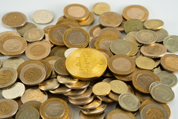 stack of coins and a bitcoin at top 