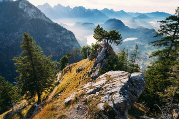 View of wild rocky mountains, high cliffs in Ammergau Alps near Schwangau. Hiking and climbing on the Tegelberg via the via ferrata at Neuschwanstein. Bavaria, Germany.
