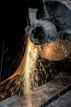 Grinding metal on a circular grinding machine with water cooling.