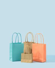 Creative shopping concept of sales, discounts and Black Friday full bags. Blue background. It's shopping o' clock.