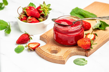 Jar of strawberry jam on white background. Homemade strawberry marmelade and fruits. Long banner...