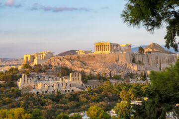 Fototapeta na wymiar Panoramic view during sunset of the Parthenon of the Acropolis seen from Filopappou Hill, Athens, Attica, Greece, Europe. Ruins of Ancient Greek temples, birthplace of democracy and civilization