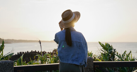 Woman look at the sunset sea view