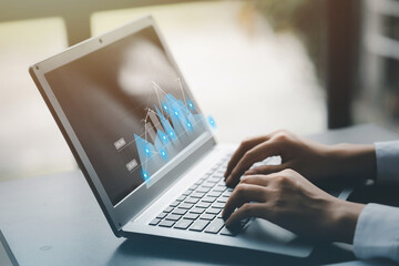 A businessman examines data on financial documents, company financial reports, graphics showing...