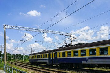 Obraz premium Vintage style electric passenger train runs on the tracks