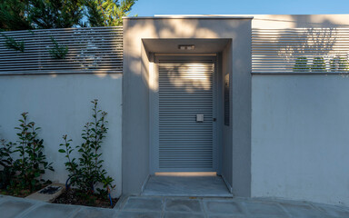 Contemporary house entrance metallic door. Tranquil Athens suburbs, Greece.