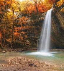 Fototapeta na wymiar Autumn waterfall and rill flow